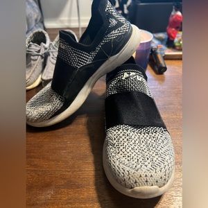 Black and white APL tennis shoes